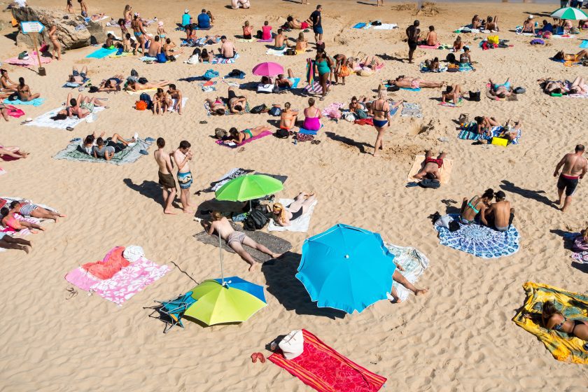 lots of people sunbathing on a beach